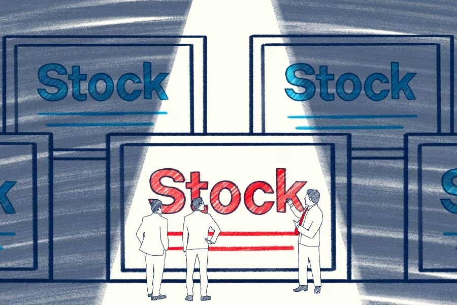 Three people looking at large art instillations of the word Stock